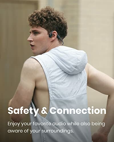 Man wearing bone conduction headphones with sleeveless hoodie.