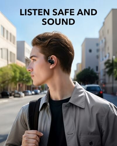 Man wearing earbuds walking in city street