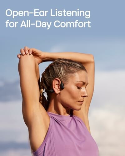 Person wearing open-ear headphones and stretching outdoors.