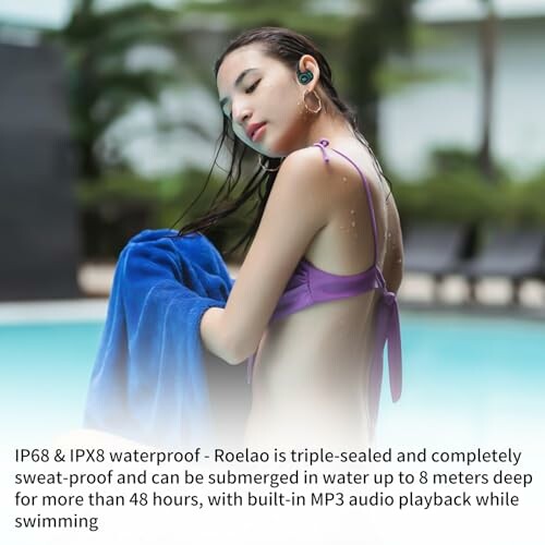 Woman wearing waterproof earbuds by a pool.