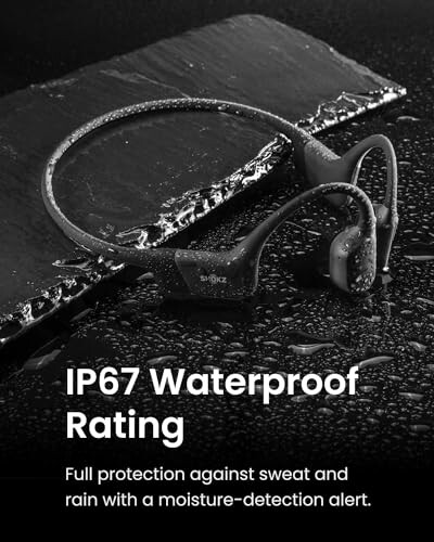 Wireless headphones with IP67 waterproof rating on wet surface.